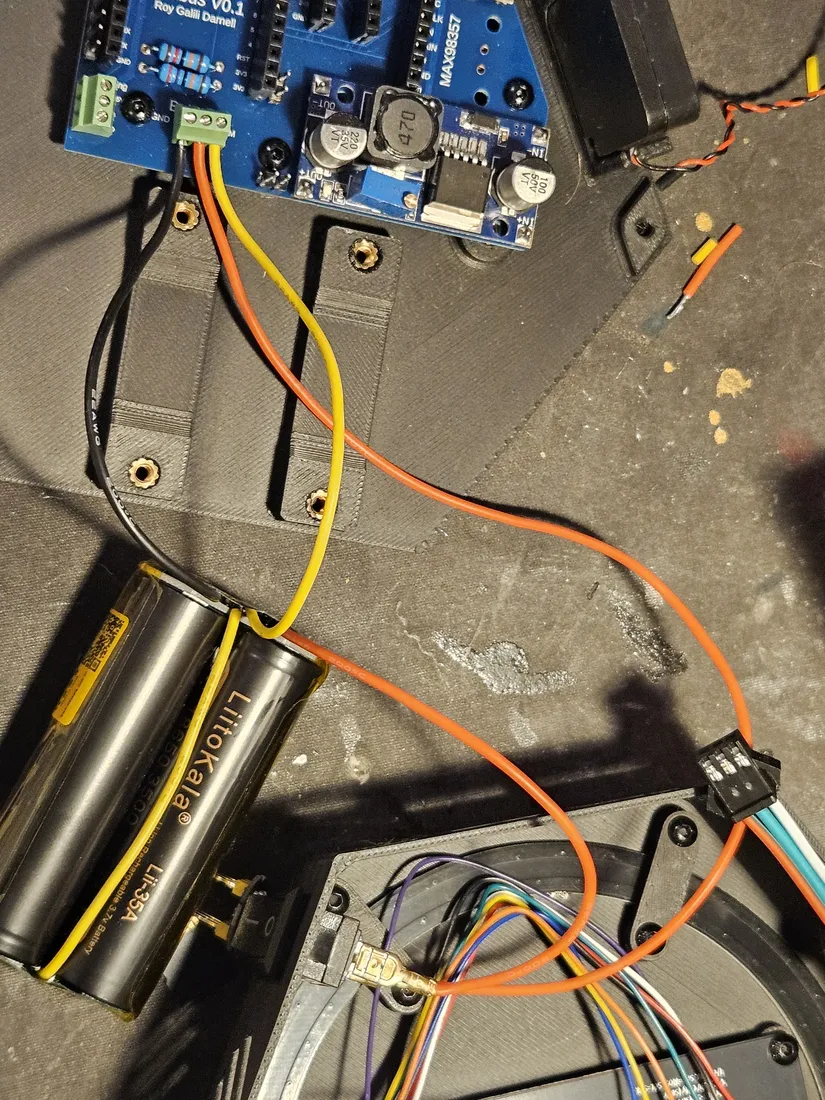 The 2S pack wired to the Nimbus V0.1 board: pack leads landing on the board power-input terminal, with the DC-DC converter on the board