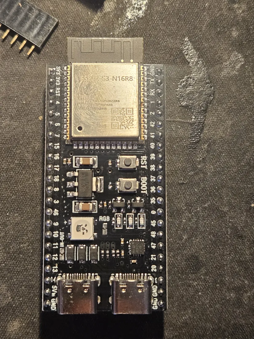 ESP32-S3-DevKitC-1 N16R8 dev board with a loose black female header strip at top left