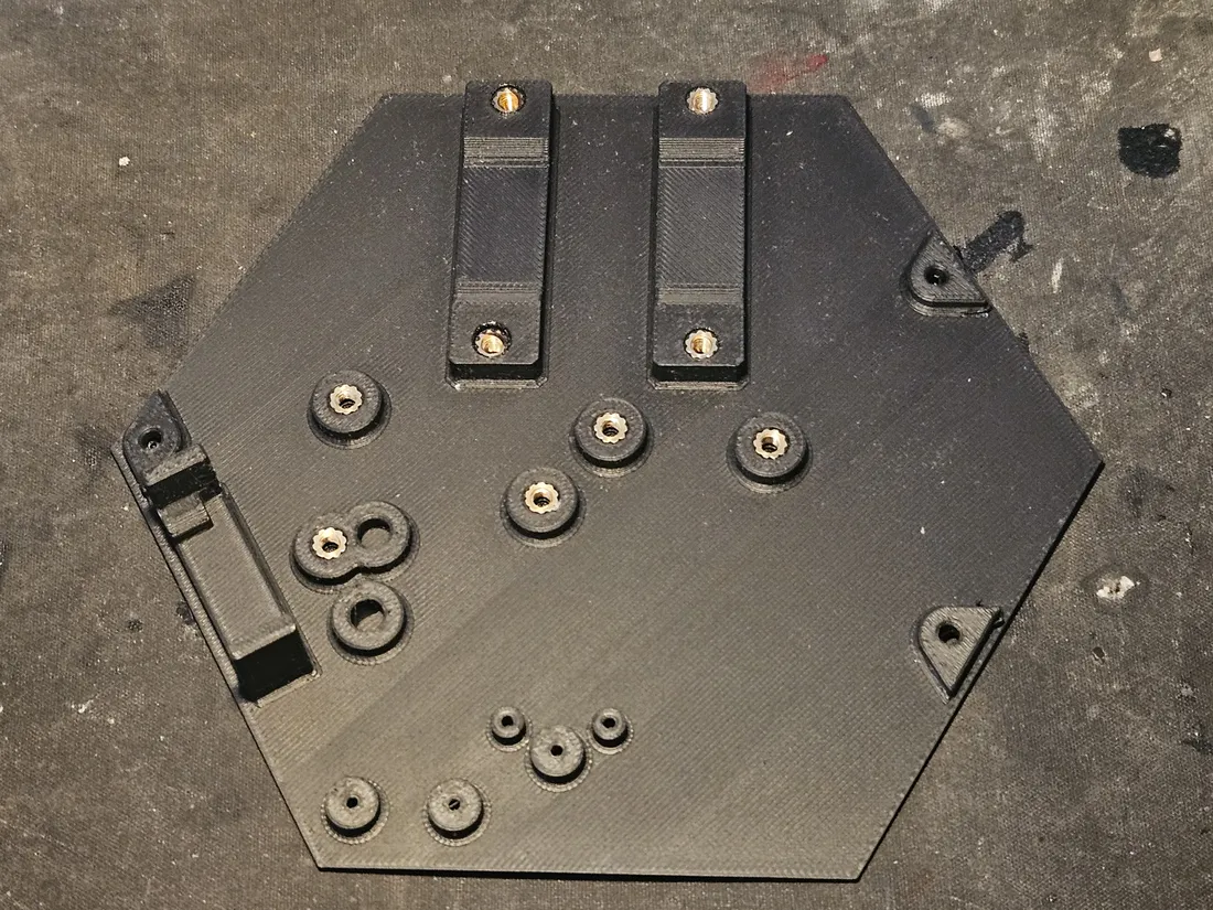 Top plate with brass inserts pressed into the two rail mounts and the standoff-boss clusters