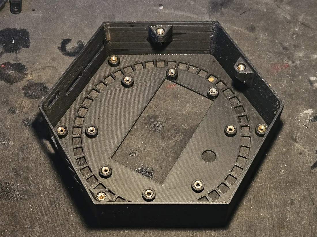 Bottom tub with brass heat-set inserts seated flush in the ring-channel bosses and corner posts