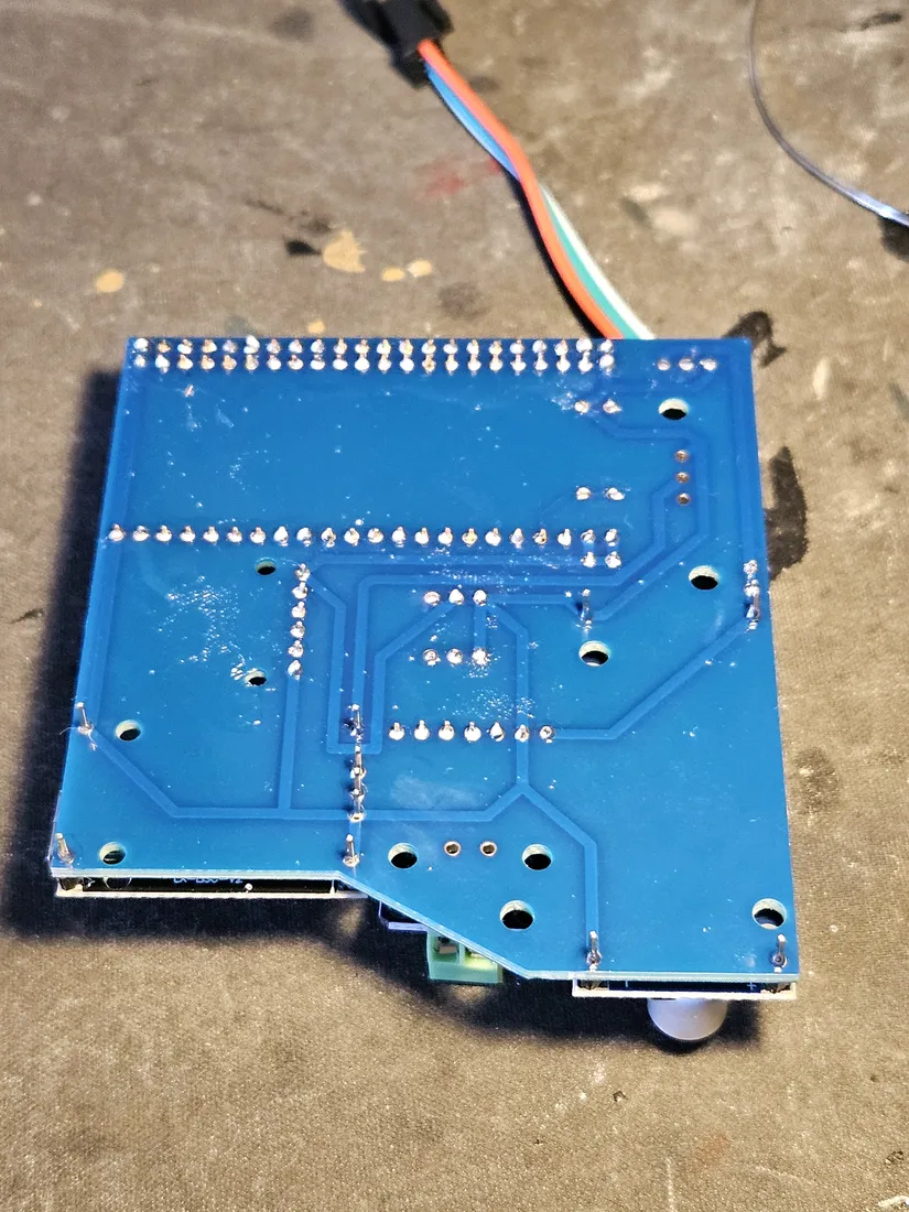 Back of the fully assembled carrier, showing the soldered header rows and the battery lead routed over the top edge