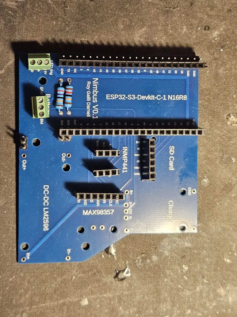 Carrier PCB with black female headers soldered into the DevKit and module rows, two divider resistors and green screw terminals in place